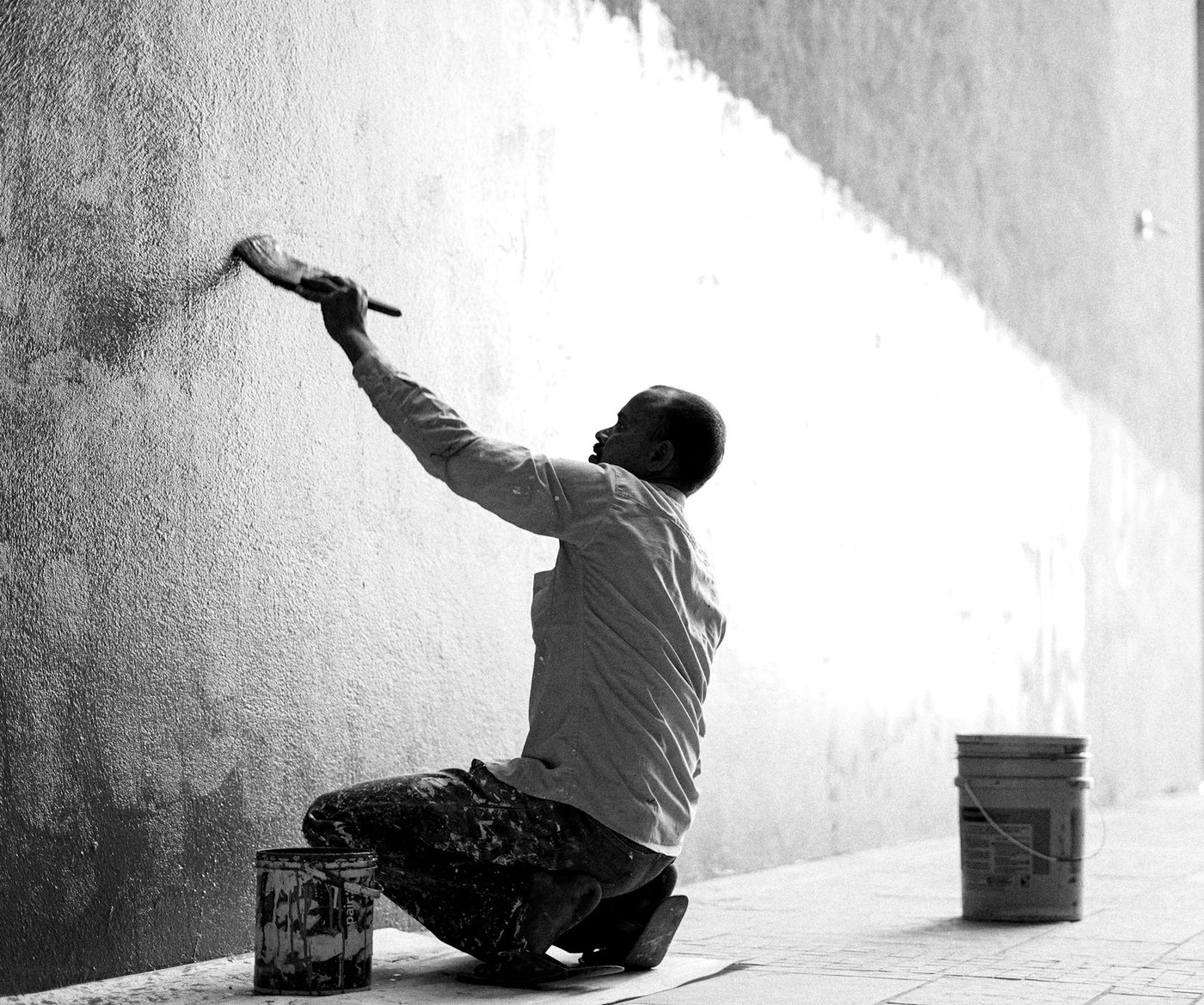 Painter applying a finish coat to an exterior wall